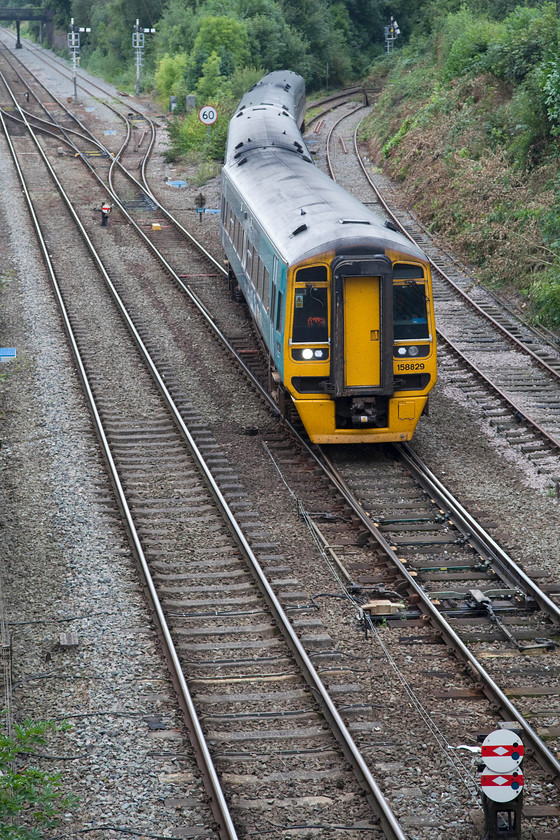 158829 & 158828, AW 11.30 Aberystwyth & 09.43-Pwllheli-Birmingham International (1G35 & 2G35), Sutton Bridge Junction 
 158829 coupled to 158828 working the 11.30 Aberystwyth/09.43 Pwllheli to Birmingham International joins the Welsh Marches Line just, south of Shrewsbury at Sutton Bridge Junction, from the Welshpool line. This junction remains a bastion of mechanical signalling with many semaphores and a smashing box just behind where I'm taking the picture from. In the foreground is a pair of shunting disk signals with white diamonds that have recently been added. This indicates that the lines that they protect have track circuits. 
 Keywords: 158829 158828 11.30 Aberystwyth 09.43 Pwllheli-Birmingham International 1G35 2G35 Sutton Bridge Junction