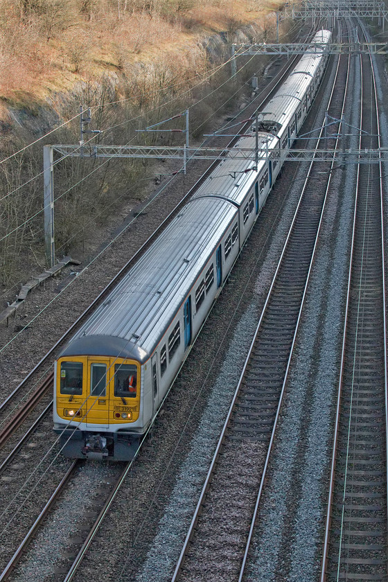 319218 & 319005, LN 14.00 Bletchley carriage sidings-Northampton EMD (5N01, 12E), Roade cutting 
 319218 and 319005 make the 5N01 short empty coaching stock move through Roade cutting. These units only work commuter services supplementing the fleet of Desiro Class 350s operated by London Northwestern. As a result of their operations, they often terminate out of position and make a number of short operational moves such as this one from Bletchley carriage sidings to the Kingsheath depot in Northampton. 
 Keywords: 319218 319005 14.00 Bletchley carriage sidings-Northampton EMD 5N01 Roade cutting