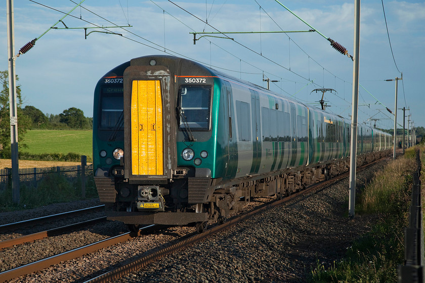 350372 & 350258, LN 18.21 London Euston-Rugeley Trent Valley, cancelled from Hednesford (9K72, 12L), Milton Malsor 
 With the sun getting helpfully low in the sky, 350372 and 350258 form the 18.21 Euston to Rugeley Trent Valley. These new workings, introduced from the summer timetable in May, involve the trains going into Birmingham New Street and splitting with the rear set going back out again to Rugeley. Unfortunately, something went wrong a little later in the day with this service, as the train was terminated at Hednesford having arrived twelve minutes late. 
 Keywords: 350372 350258 18.21 London Euston-Rugeley Trent Valley 9K72 Milton Malsor