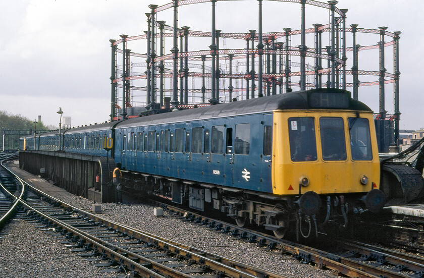 Class 127 DMU, 16.03 Luton-London St. Pancras, London St. Pancras station 
 The gasometers just north of St. Pancras station were visual features of the area for many years and look to be, in this image at least, to be in good condition. Today these iconic structures live on with them being at the core of some very upmarket flats and apartments with one even surrounding a park and recreation area. Back when this image was taken this rather run-down part of North London was one avoided by most but the gentrified transformation of this area is now quite extraordinary helped in no small part by the rebuilding of St. Pancras station itself in the early 2000s. In this view, the 16.03 Luton to St. Pancras service arrives at its destination being worked by a pair of the excellent but by now virtually life expired Class 127 DMUs. 
 Keywords: Class 127 DMU 16.03 Luton-London St. Pancras, London St. Pancras station Bedpan