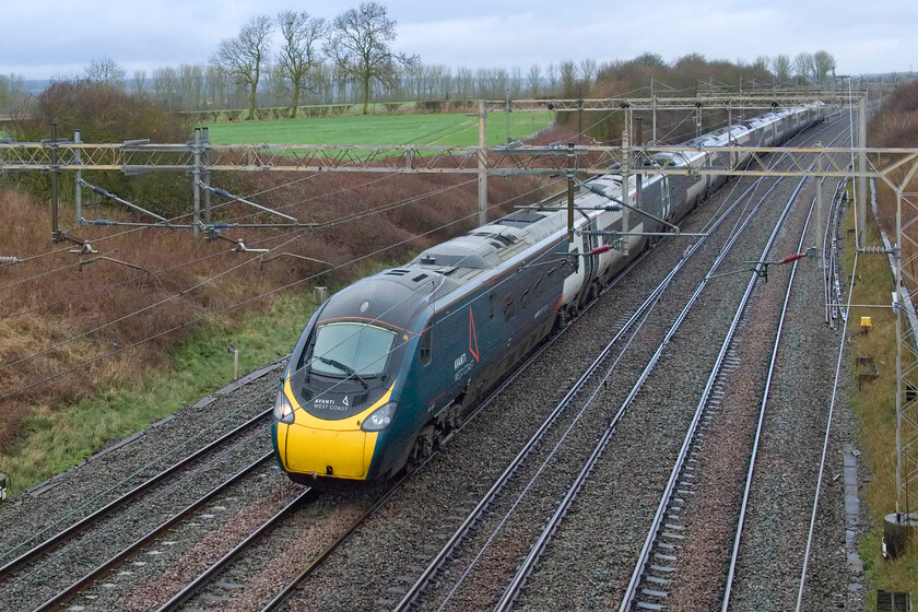 390154, VT 07.21 Birmingham New Street-London Euston (1B25, 15L), Castlethorpe SP790453 
 With the rain having eased off 390154 passes south working the 1b25 07.21 Birmingham New Street to London Euston service. The photograph is taken from a very isolated occupation bridge between the village of Castlethorpe and Hanslope Junction just north of Milton Keynes. 
 Keywords: 390154 07.21 Birmingham New Street-London Euston 1B25 Castlethorpe SP790453 AWC Avanti west coast pendolino