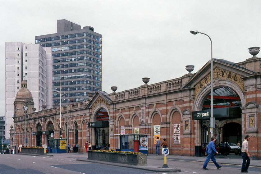 Frontage, Leicester station 
 The original Leicester station was designed by William Parsons in the Grecian Revival style, with a two-storey main building which was embellished with a central pediment set forward on fluted columns in front flanked by short single-storey wings and was opened in 1840. In 1892 this was replaced by the station building seen here designed by Midland's favoured architect Charles Trubshaw. The London Road frontage seen here features four entrance archways. Above each of the left-hand pair the word Departure was inscribed and, above each of the other two, the word Arrival was carved in relief. These signs were to assist horse-drawn cab drivers when dropping passengers who intended to catch departing trains, or were plying for hire by passengers who had arrived by train. Notice the clock at the far end of the station. To this day it remains the final example of a hand-wound station clock throughout the network. Incidentally, at the time of writing in 2023, there are ambitious plans in place to completely redevelop Leicester station providing it with a rather grand new entrance and pedestrianised concourse to the western side located to the right of the clock tower seen in this image. 
 Keywords: Frontage Leicester station Midland Railway