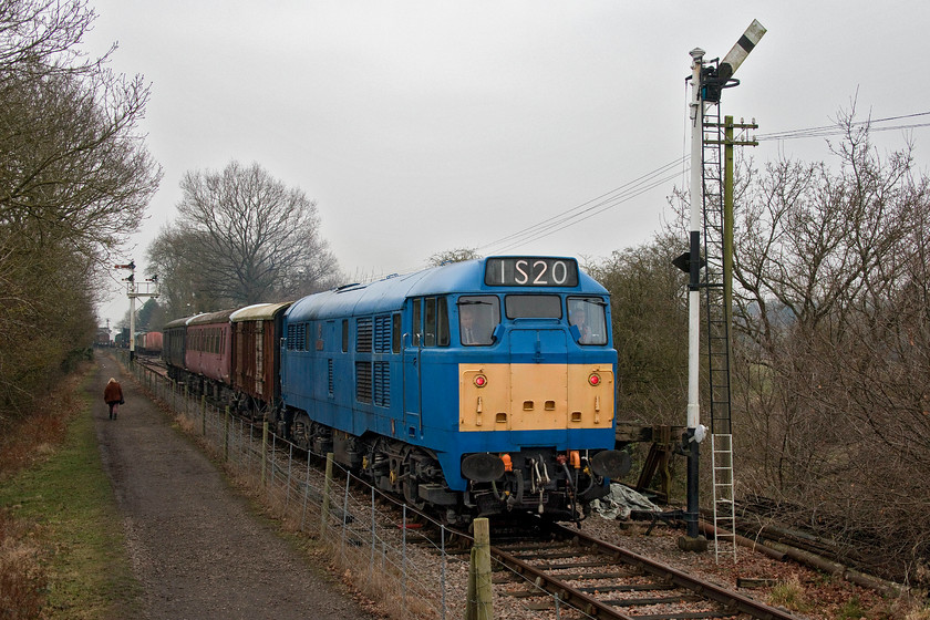 31289, 11.00 Pitsford return, bridge 13 
 Carrying a highly improbable 1S20 reporting number (14.00 King's Cross - Aberdeen) 31289 'Phoenix' is about to cross Bridge 13 on the Northampton and Lamport Railway. It is leading the 11.00 return mince pie special that will run up the line a short distance and then return again back through the station in the distance. Notice that 31289 is displaying its red tail lights even though this cab is leading. 
 Keywords: 31289, 11.00 Pitsford return, bridge 13 NLR Northampton and Lamport Railway