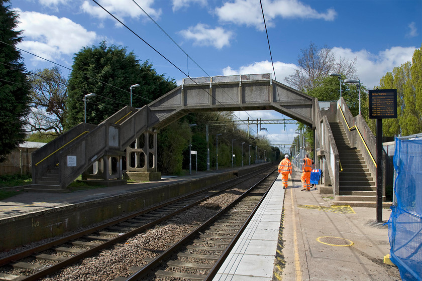 Footbridge to be removed weekend 18-21.04.14, Weeley station 
 Contractors survey their work area on Weeley station in preparation for work to take place over the coming Easter bank holiday weekend. The concrete station footbridge, installed when the line was electrified in 1959, was due to be removed over the four-day closure of the line and a TUM 400 Steel Footbridge by VEEDA associates. The old bridge was an 'Exmouth' precast reinforced concrete footbridge spanning the two tracks with dog-leg staircases to each platform that was described as being life expired' and one that did not meet disability access requirement. 
 Keywords: Footbridge to be removed weekend Weeley station