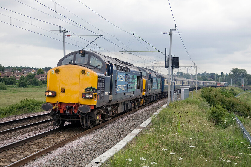 37605, 37602 & 57309, outward leg of The Three Peaks Challenge, London Euston-Bangor (1Z51), Wilson's crossing 
 This was the photograph that nearly took my index finger off....well not quite! This image was taken from the top of my step ladder raising me above the palisade fencing. It shows 37605 and 37602 leading the outward leg of the Three Peaks Challenge charter that had set off from Euston and was heading to Bangor running as 1Z51. I had intended to take a going away photograph of 57309 'Pride of Crewe' at the rear but as I turned my ladder started to tip over with me attempting to prevent this but in doing so caught my right index finger on the top spike of the palisade fencing slicing it open. Needless to say, I did not get the shot but did manage to get myself to casualty with the badly injured finger wrapped in a lens cloth tightly held together with some cable ties from my camera bag. Many thanks to an unknown fellow enthusiast who packed my camera equipment away whilst I was trying to keep myself compos mentis!

NB some six years later the scar is still very much in evidence and the nerves appear to be very slowly growing back with some tingling sensation returning to the end of the finger. 
 Keywords: 37605 37602 57309 outward leg of The Three Peaks Challenge London Euston-Bangor 1Z51 Wilson's crossing DRS Direct Rail services Pride of Crewe