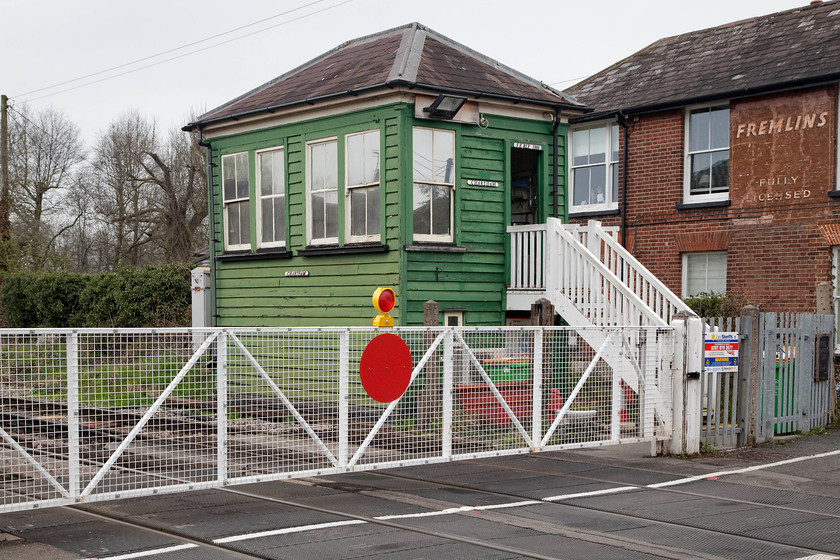 Chartham Signal Box (SER, 1885) & crossing gates 
 The South Eastern Railway opened its signal box at Chartham in 1885. It remains virtually as built, apart from the unusual green paint scheme! It is built of typical clapboard construction as were much of there structures. The former Railway Arms pub can be seen behind the box. Fremlins brewery was in Maidstone and was a large Kent brewer. It closed in 1972 following the inevitable takeover by Whitbread. The old brewery is now a Tesco supermarket in Maidstone. 
 Keywords: Chartham Signal Box