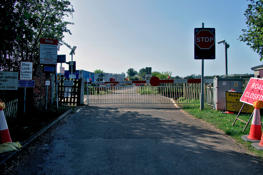 Langham Road (Ashwell Gate House) level crossing 
 It is no wonder that there are accidents at level crossings! Just look at the huge array of signage in this view of Langham Road level crossing also known as Aswell Gate House crossing. Admittedly, it is a little unusual in that the gates remain closed to road users and pedestrians with them having to contact the signalmen in the nearby Ashwell signal box for permission to cross. However, it is a messy jumble of signage that would only go on to confuse the unwary. As can be seen from the yellow road closure notice Network Rail are undertaking some work to hopefully simplify its operation. 
 Keywords: Langham Road Ashwell Gate House level crossing