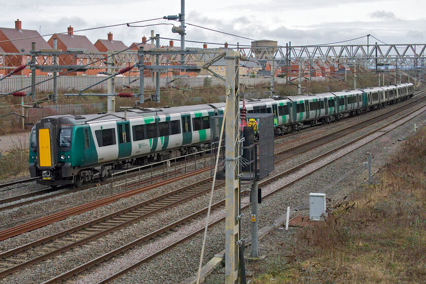 350377 & 350245, LN 13.22 London Euston-Birmingham New Street (1Y27, 3E), site of Roade station 
 Standing at the extreme southern end of Roade's cutting on Bridge 206 known in the village as the Gravel bridge sees 350377 and 350245 heading north with the 13.22 Euston to Birmingham service. This location was, until 1964, the site of Roade's station of which there are persistent discussions about its reopening but this is not going to happen any time soon! 
 Keywords: 350377 350245 13.22 London Euston-Birmingham New Street 1Y27 site of Roade station London Northwestern Desiro