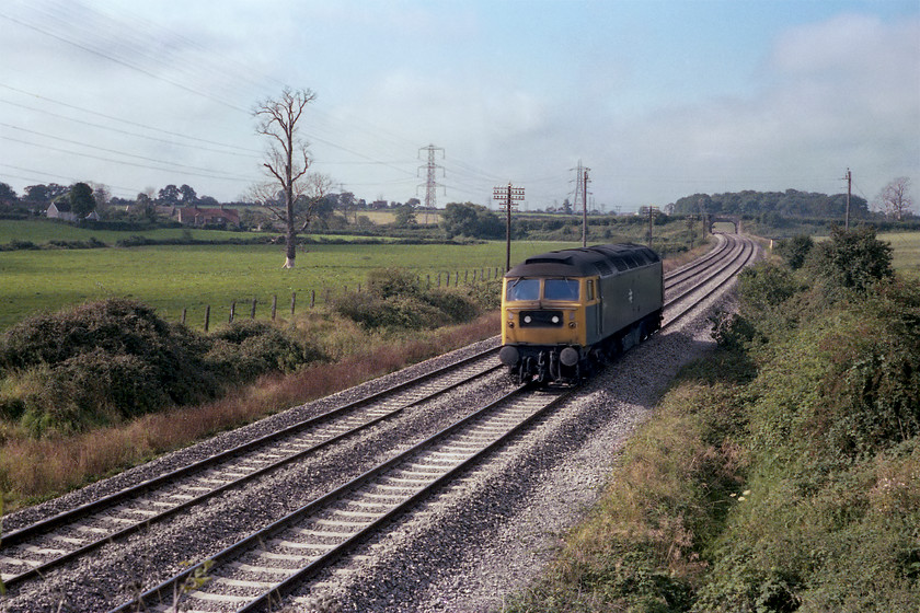 47142, up LE, Berkley ST805497 
 47142 heads light engine from the west towards Westbury. The picture is taken near to Berkeley on the outskirts of Frome. This scene is essentially the same today but for some vegetation growth. Obviously, the huge dead elm tree in the field to the left has long gone! 
 Keywords: 47142 up LE Berkley ST805497