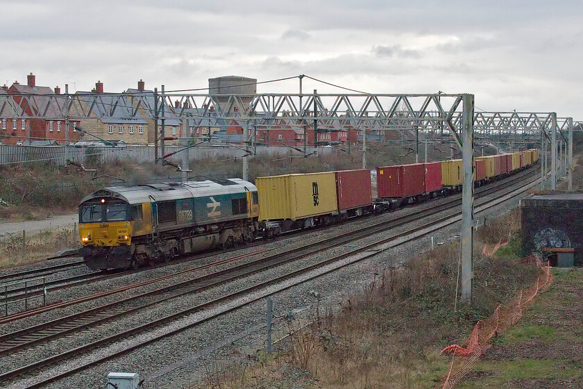 66789, 14.07 Wembley Yard-Hexthorpe Yard (4E11, 67E), site of Roade station 
 The reporting number of 4E11 has not been mentioned on this website before. This is because it usually runs at night from Felixstowe to Hexthorpe (Doncaster) via Ely, Peterborough and Lincoln. However, due to the complete planned closure of Peterborough due to engineering works it has been forced to make a substantial daytime diversion to Wembley and then north along the WCML to Birmingham and onwards to via Toton, Barrow Hill and Mexborough. Looking in need of a clean, celebrity 66789 British Rail 1948-1997 leads the train past Roade on a very dull Sunday afternoon. 
 Keywords: 66789 14.07 Wembley Yard-Hexthorpe Yard 4E11 site of Roade station British Rail 1948-1997