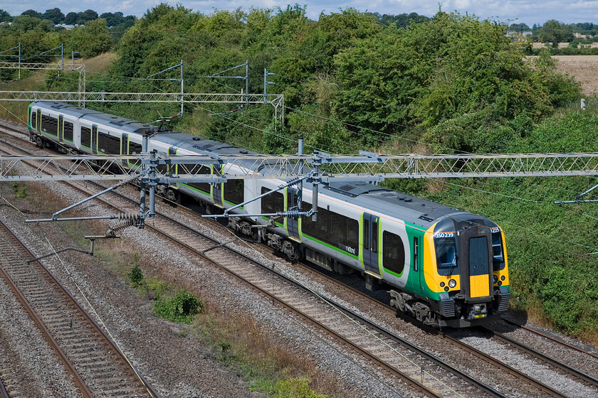 350239, LM 12.14 Birmingham New Street-London Euston, Victoria bridge 
 In some warm afternoon sunshine, the 12.14 Birmingham to London Euston London Midland service passes Victoria bridge near Roade worked by 350239. 
 Keywords: 350239 12.14 Birmingham New Street-London Euston Victoria bridge London Midland Desiro