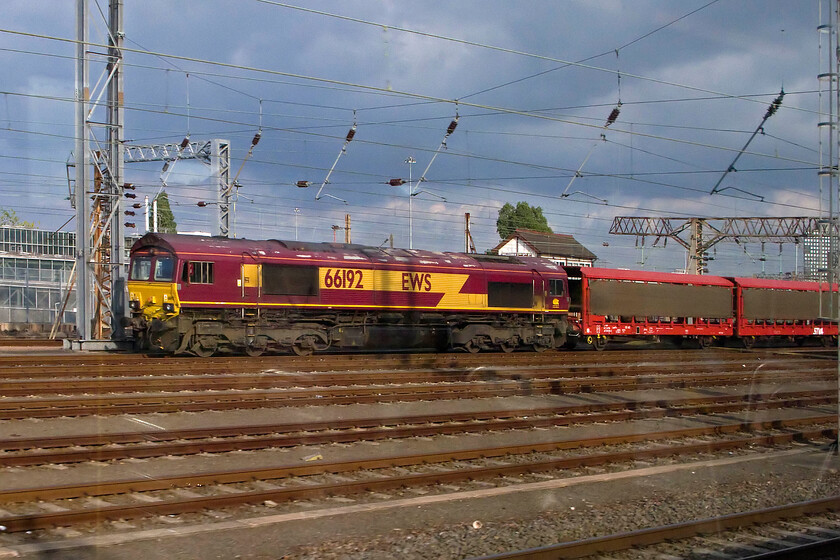 66192, stabled, Wembley Yard 
 With the gable roof of Willesden Carriage Shed North signal box just appearing above the roof of 66192 we race past on our journey back to Milton Keynes. I have not been able to discover what train the Class 66 was working but there is an occasional diverted empty car train down the WCML from Southampton on a Sunday afternoon that would normally travel via the Oxford and Banbury GW route so I can only assume that it is this....advice anybody? 
 Keywords: 66192 Wembley Yard