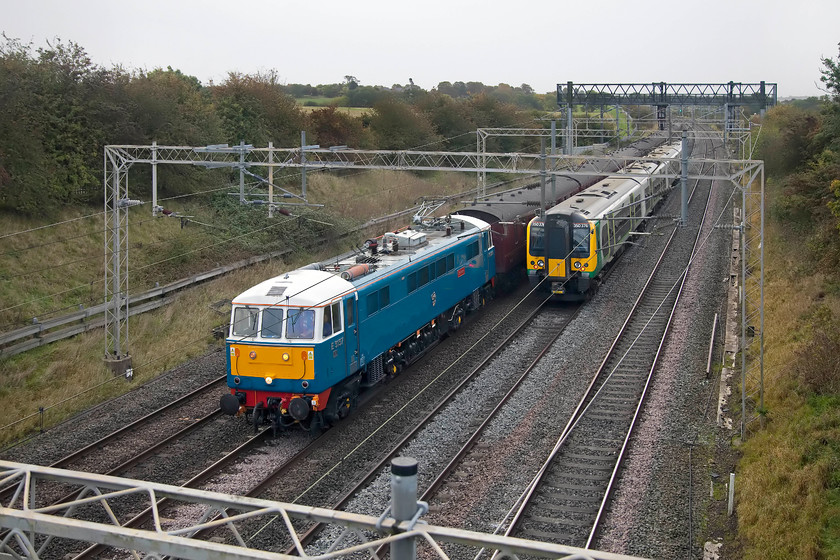 86259, outward leg of The Cumbrian Coast Express, 07.10 London Euston-Carlisle (1Z86) & 350376, LM 06.01 Crewe-London Euston (1U16, RT), Castlethorpe SP790453 
 I saw this situation developing in front of my eyes on Open Train Times as both these train approached me! However, just for once, the photography gods were with me as 350376 forming the 06.01 Crewe to Euston just got out of the way. It's a shame that the coaching stock of the The Cumbrian Coast Express is obscured but at least 86259 'Les Ross/Peter Pan' is in full view as it heads north with the 1Z86 excursion. The trains are seen just north of castlethorpe between Wolverton and Hanslope Junction on the WCML. 
 Keywords: 86259 The Cumbrian Coast Express 07.10 London Euston-Carlisle 1Z86 350376, 06.01 Crewe-London Euston 1U16 Castlethorpe SP790453