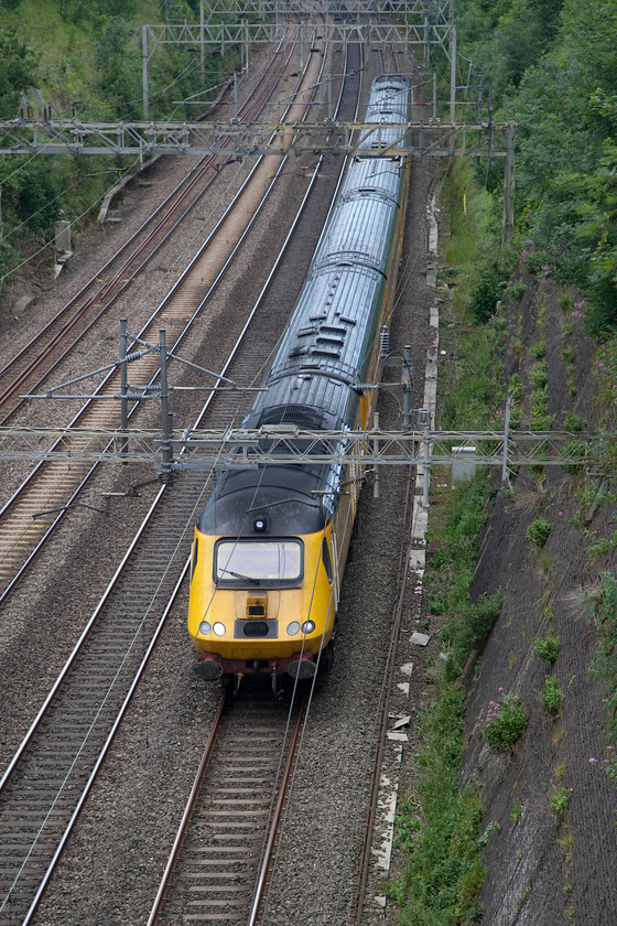 43013 & 43062, 12.27 Crewe LNWR-Derby RTC (1Q27), Roade Cutting 
 A fairly regular working on the WCML is the Network Measurement Train (NMT). On Wednesdays it usually does a circular route including a flying trip to Euston and back on the fast lines. Here, it is returning to Derby RTC as 1Q27 passing through Roade Cutting. It is believed that the front power car is 43013, the rear one is 43062. 
 Keywords: 43013 43062 1Q27 NMT Roade Cutting