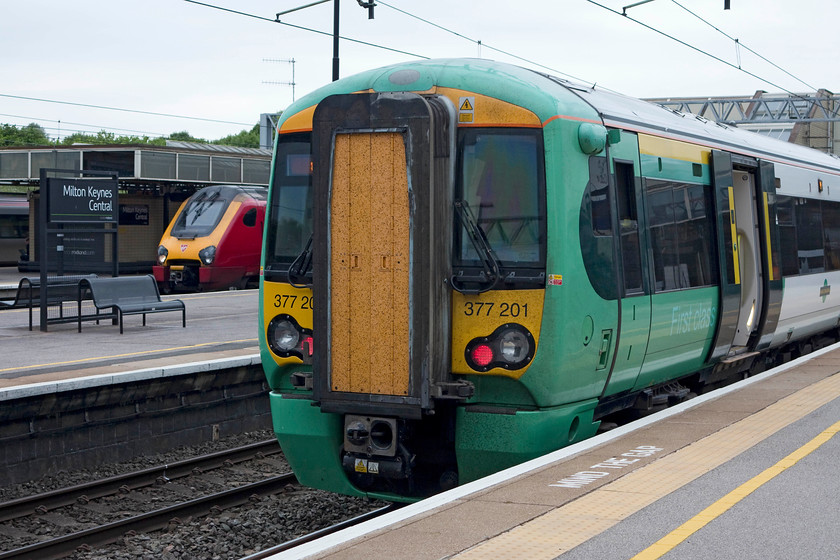 Class 221, VT 09.35 Chester-London Euston (1A18, 1E) & 377201, SN 09.10 East Croydon-Milton Keynes (2M25, RT), Milton Keynes station 
 A Virgin class 221 waits to leave Milton Keynes with the 09.35 Chester to Euston. In the foreground, 377201 has just arrived and terminated with the 09.10 from East Croydon. 
 Keywords: Class 221 1A18 377201 2M25 Milton Keynes station