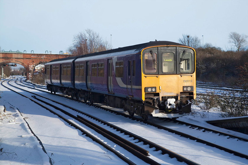 150112, NT 15.56 Knottingley-Knottingley ECS (5F24), Knottingley station 
 Having had a brief layover near to Knottingley MPD, 150112 glides into Knottingley station as the 5F24 ECS. It will then pick up the few passengers present, mainly made up of school children, and work back towards Leeds. 
 Keywords: 150112 5F24 Knottingley station