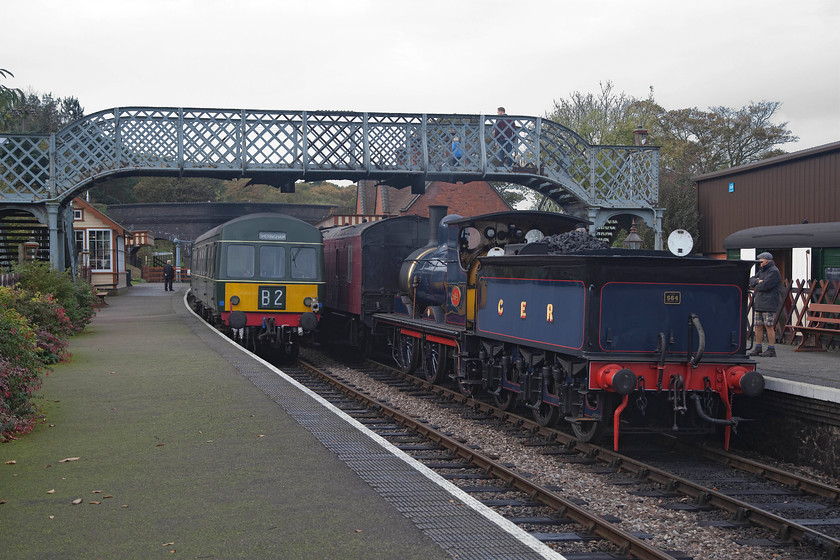 M51192 & M56352, 11.20 Sheringham-Holt & 564, 11.25 Holt-Sheringham, Weybourne station 
 The usual service pattern on the NNR is that trains pass at Weybourne that is located about equidistant between Sheringham and Holt. This means that there are busy times when this happens and some incongruous combinations of motive power. Here is one such combination, a class 101 DMU formed of M51192 and M56352 waits with the 11.20 Sheringham to Holt whilst 0-6-0 GER Y12 564 is ready with the 11.25 Holt to Sheringham. After the noisy activity and the two trains have departed, peace and tranquility returns to this delightfully restored rural station. 
 Keywords: M51192 M56352 11.20 Sheringham-Holt 564 11.25 Holt-Sheringham Weybourne station