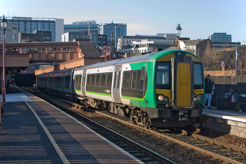 172339, LM 14.57 Stourbridge Junction-Stratford-on-Avon (2S54), Birmingham Moor Street station 
 With the skyscape of central Birmingham in the background, London Midland's 172339 stands in Moor Street station's platform one. It is working the 14.57 Stourbridge Junction to Stratford-on-Avon and has just emerged from the tunnel that links under the city to Snow Hill station. 
 Keywords: 172339 14.57 Stourbridge Junction-Stratford-on-Avon 2S54 Birmingham Moor Street station