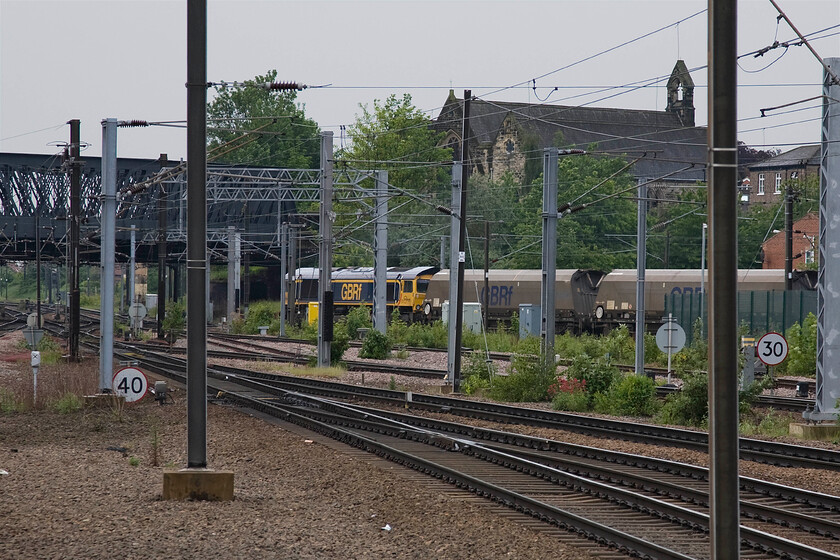 66742, 06.23 Tyne Coal Terminal-Drax coal train, York Yard South Junction (from York station) 
 66742 'ABP Port of Immingham Centenary 1912-2012' avoids York station rejoining the mainline at York Yard South Junction. The GBRf Class 66 is leading the 06.23 Tyne Coal Yard to Drax power station loaded coal train. Back in 1980, I stood under Holgate bridge taking photographs looking back towards where I am standing now, see..... https://www.ontheupfast.com/p/21936chg/29385166204/x55002-15-50-york-london-king-s-cross 
 Keywords: 66742 06.23 Tyne Coal Terminal-Drax coal train, York Yard South Junction from York station ABP Port of Immingham Centenary 1912-2012