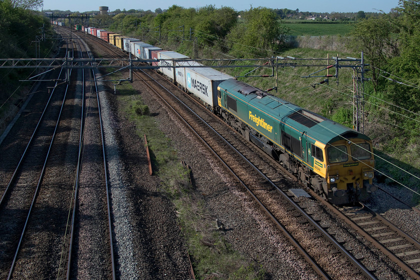 66544, 12.57 Birch Coppice-Felixstowe North (4L57, 4E), Victoria bridge 
 A very long 12.57 Birch Coppice to Felixstowe Freightliner stretches off into the distance at Victoria bridge in Northamptonshire. The daily 4L57 working is being led by 66544, a member of the class that I photographed a number of times at various locations. I like photographing from this angle as my house always features in the background! 
 Keywords: 66544 12.57 Birch Coppice-Felixstowe North 4L57 Victoria bridge Freightliner