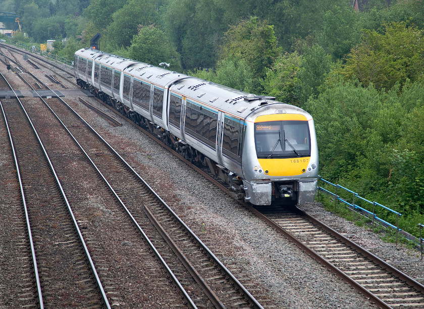 166107, CH 10.35 London Marylebone-Oxford (1T23, 2E), Walton Well Bridge 
 Chiltern Railways 166107 drifts in to Oxford past Walton Well Bridge about to complete its journey, the 10.35 from London Marylebone. Whilst the livery of these units is bright compared with many, against a dark background on a dull day, such as this, it does create some contrast issues for the camera to deal with! 
 Keywords: 166107 1T23 Walton Well Bridge