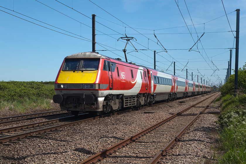 91112, GR 13.00 London King`s Cross-Edinburgh (1S18, 1L), Barnby Lane SK850495 
 91112 leads the 13.00 King's Cross to Edinburgh express past Barnby Lane to the north of Claypole. The relatively short Claypole down loop can be seen in the foreground. I have said it before but make no apologies for repeating it, I think that this former Virgin East Coast livery with subtle state-owned LNER branding is the best of the varied ones carried by this stock on this route. 
 Keywords: 91112 13.00 London King`s Cross-Edinburgh 1S18 Barnby Lane SK850495