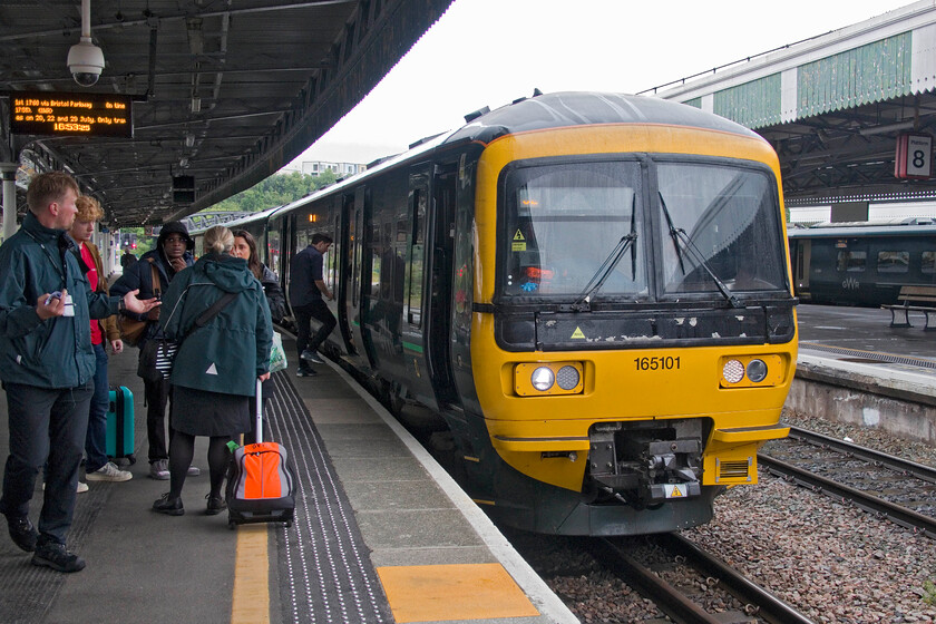 165101, GW 15.59 Westbury-Gloucester (2E71, 3L), BristolTemple Meads station 
 A picture that tells a story that is all too common on our railways. We did not know it yet but the GWML Badminton route (from Wootton Bassett to Westerleigh Junctions) was shut due to signalling issues so passengers wishing to head for South Wales would face problems. However, at the point that I took this photograph, there was utter confusion with just an awareness for passengers that they would not be able to travel west from Bristol Parkway with no information as to what they should do instead. Whilst one GWR staff member attempts to help passengers the other walks away seemingly unable (or unwilling?) to help. It's come to something when control cannot inform their staff as to what is going on and tell them what they should be telling their customers. 165101 was full and standing working the 15.59 Westbury to Gloucester service with passengers who were eventually advised (some by Andy and me using RTT) to travel to Gloucester to then pick up either a CrossCountry service to South Wales or a diverted (via the Golden Valley) GWR IET if it was to make an additional stop; something that was unknown at this point. The lady that we helped was worried that her ticket did not cover the revised route with Andy and I reassuring her that this would not be a problem as the fault was not hers. It's come to something when a couple of railway enthusiasts end up helping and advising passengers ahead of the operating companies! 
 Keywords: 165101 15.59 Westbury-Gloucester 2E71 BristolTemple Meads station GWR Turbo