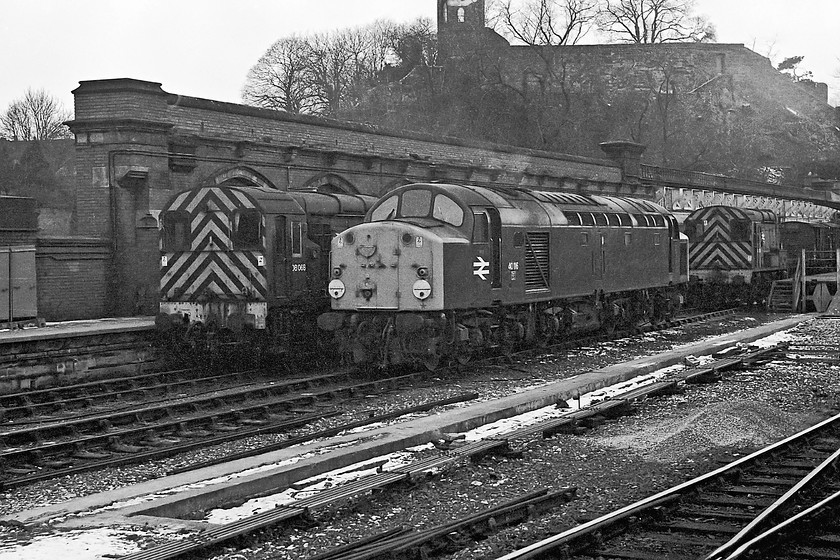 08068, 40116 & 08055, stabled, Shrewsbury station yard 
 On the approach to Shrewsbury station, with the castle in the background, 08068, 40112 and 08055 are seen stabled in the loading bay sidings. All these locomotives ended heir days being cut up at Swindon works in 1983, 1981 and 1983 respectively. Both the shunters were out-sheded from Crewe Diesel Depot. 08055 was an early example that was allocated to Woodford Halse (38E) on the Great Central when new from the works 
 Keywords: 08068 40116 08055 Shrewsbury station yard