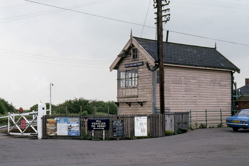 New Holland Town signal box (RSCo, 188X) & level crossing 
 A reverse angle view of New Holland Town signal box with the crossing gates that permitted access for vehicles to the pier itself. Vehicle access to the pier enabled them to then join the Humber ferry that docked at the end of the pier. The box looks to be remarkably original with its finials, slate roof, and timber cladding. It is recognisable as a Railway Signalling Company (RSCo) structure but I cannot find a decisive date for its construction but I suspect that it would be very close to the nearby Barrow Road Crossing box date of 1885. As for the November 1972 registered Ford Escort, the DVLA records indicate that it had another six years on the road before the inevitable rust would have probably confined it to the scrap yard! 
 Keywords: New Holland Town signal box RSCo level crossing Ford escort