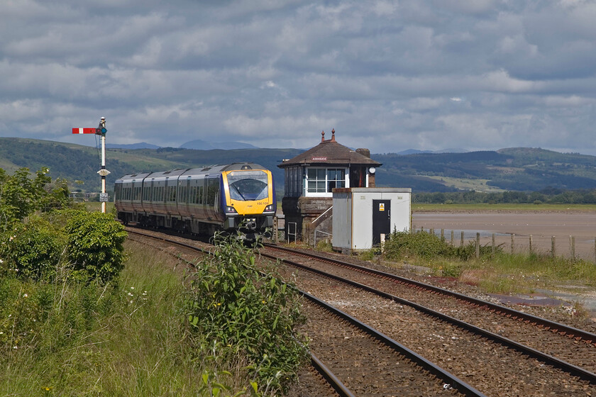 195109, NT 10.49 Barrow-in-Furness-Manchester Airport (1Y95, 1L), Arnside station 
 Under an interesting sky, emphasised by the zoom effect of the lens, 195109 arrives at Arnside station passing the superb Furness 1897 box working the 10.49 Barrow-in-Furness to Manchester Airport Northern service. The train has just crossed five hundred metres long Kent Viaduct (also known as the Arnside Viaduct) just off to the left behind the shrubs. 
 Keywords: 195109 10.49 Barrow-in-Furness-Manchester Airport 1Y95 Arnside station Northern