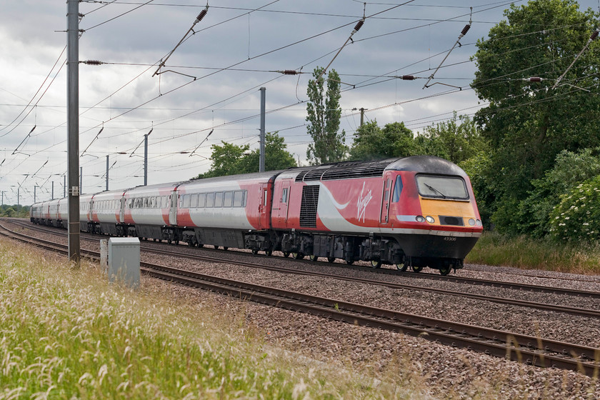 43306 & 43274, GR 15.04 London King`s Cross-York (1N87, 15L), Offord D`Arcy TL213652 
 43306 and 43274 at either end of the 1N87 15.04 London King's Cross to York take the reverse curves at Offord D'Arcy. Whilst it makes for an interesting picture to see a fast express leaning into curves, I suspect that the passengers cosseted in their comfortable Mk. III coaches would not even notice! 43306 has always been an Eastern Region power car being delivered as 43106 forming part of the 254026 set. 43274 was initially numbered 43074 as part of 254010, also an Eastern Region set. 
 Keywords: 43306 43274 1N87 Offord Darcy TL213652