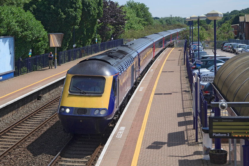 43127, GW 11.34 London Paddington-Exeter St. David s (1C81, RT), Hungerford station 
 43127 'Sir Peter Parker 1924 - 2002 Cotswold Line 150' passes Hungerford station with the 11.34 Paddington to Exeter St. David's service. I have a similar picture taken in 1978 and it shows a virtually empty gravel car park to the right and where the houses are a huge area of derelict land with the old goods shed still standing in the middle. 
 Keywords: 43127 1C81 Hungerford station