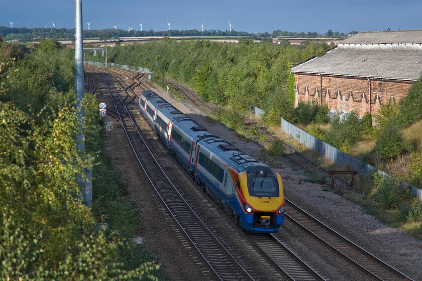 222023, EM 14.36 Nottingham-London St. Pancras (1C57), Mill Road bridge 
 The time of day has finally caught up with me! 222023 working the 14.36 Nottingham to St. Pancras 'fast' service is about to pass under Wellingborough's Mill Road bridge. Still basking in the afternoon sunshine to the right is the former Wellingborough Shed (15A>08.63 & 15B<08.63-05.73). There are plans on the table for this building including turning it into a supermarket! On the skyline is the twenty megawatts Burton Wold Wind Farm that opened seven years ago in May 2006. 
 Keywords: 222023 14.36 Nottingham-London St. Pancras 1C57 Mill Road bridge EMT East Midlands Trains meridian