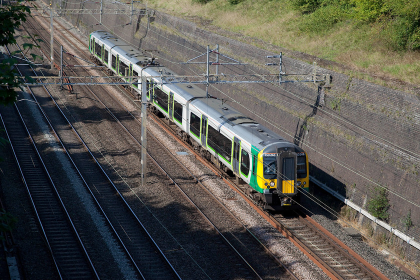 350246, LM 14.14 Birmingham New Street-London Euston (1Y52,-RT), Roade Cutting 
 350246 in the glorious bank holiday sunshine passes through Roade Cutting working the 14.14 Birmingham New Street to London Euston. Who said it always rains on bank holidays? 
 Keywords: 350246 1Y52 Roade Cutting