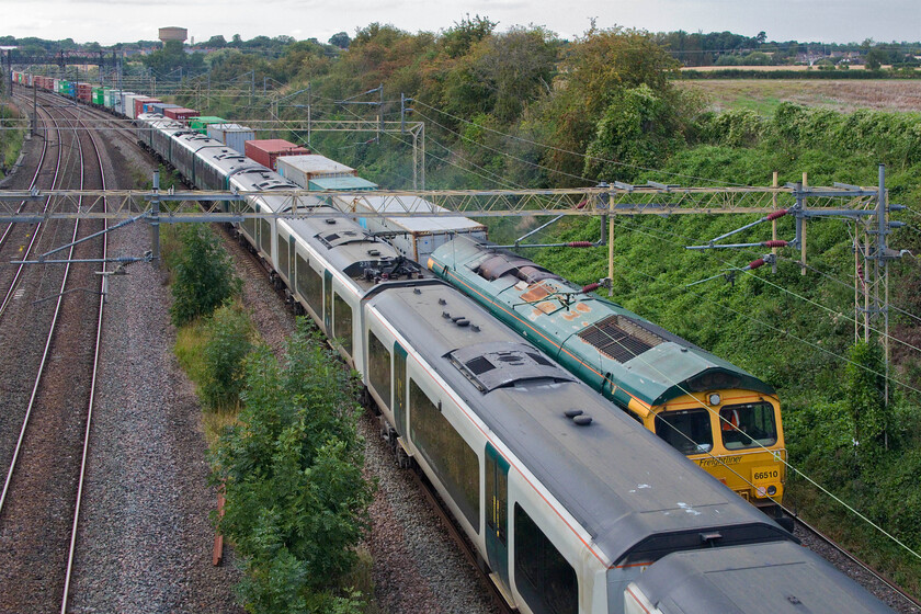 350239, LN 16.26 London Euston-Birmingham New Street (1Y53, 2L) & 66510, 12.20 Trafford Park-Felixstowe (4L90, 7L), Victoria bridge 
 Bowled! Luckily, 66510 is a member of the class that I have photographed in the past so I was not too put out that the 16.26 Euston to Birmingham New Street service got in the way! The 66 was leading the 4L90 12.20 Trafford Park to Felixstowe Freightliner with bot trains seen at Victoria bridge just south of Roade. 
 Keywords: 350239 16.26 London Euston-Birmingham New Street 1Y53 66510 12.20 Trafford Park-Felixstowe 4L90 Victoria bridge London Northwestern Freightliner