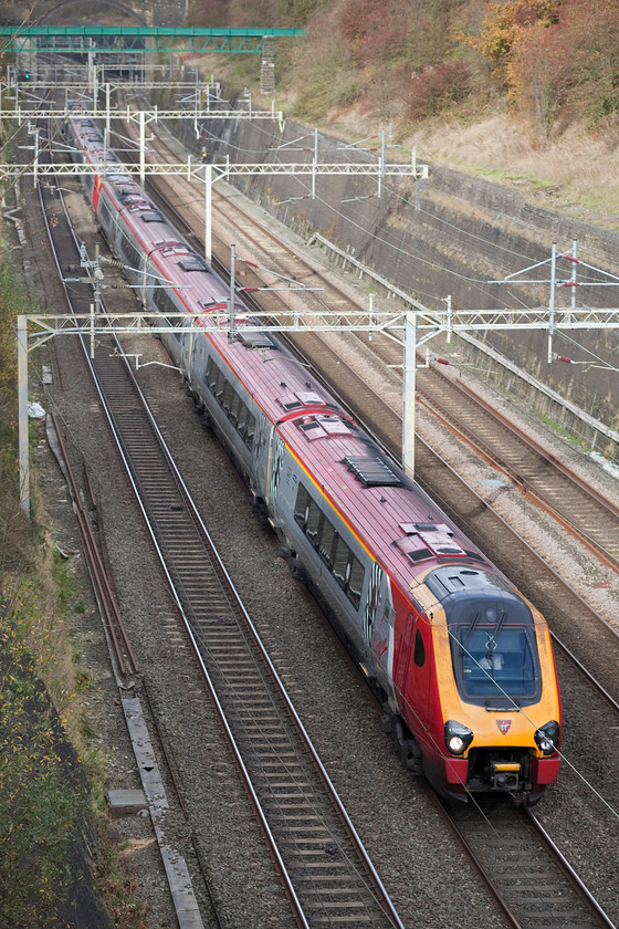 Class 222s, VT 06.52 Edinburgh Waverley-London Euston (9M50), Roade cutting 
 The Anglo Scottish 9M50 06.52 Edinburgh to Euston composed of two class 221s passes south through Roade cutting. What an expensive way to run a railway, double manning throughout and using up gallons of diesel. What would be wrong with operating a set of refurbished Mk.III coaches hauled by a class 90; the customer experience would be so much better and, even including higher track access charges, I am sure that it would be cheaper to operate. 
 Keywords: Class 222s 06.52 Edinburgh Waverley-London Euston 9M50 Roade cutting