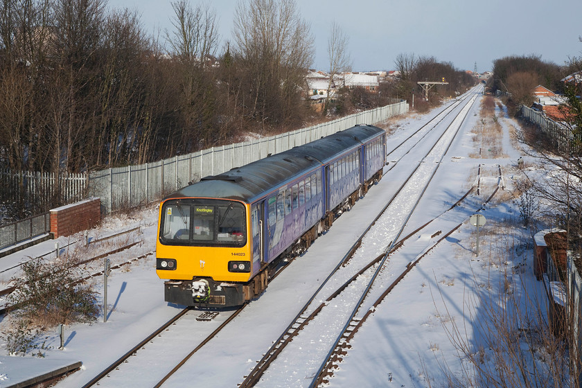 144023, NT 15.00 Leeds-Knottingley (2F21, RT), Pontefract Monkhill station 
 Leaving one of Pontefract's three stations, 144023 is seen working the 15.00 Leeds to Knottingley 2F21 working. Looks can be deceiving, despite the sun being out it was a bitterly cold late afternoon at Pontefract Monkhill with the temperature being way below freezing and a strong and bitter wind blowing. 
 Keywords: 144023 2F21 Pontefract Monkhill station