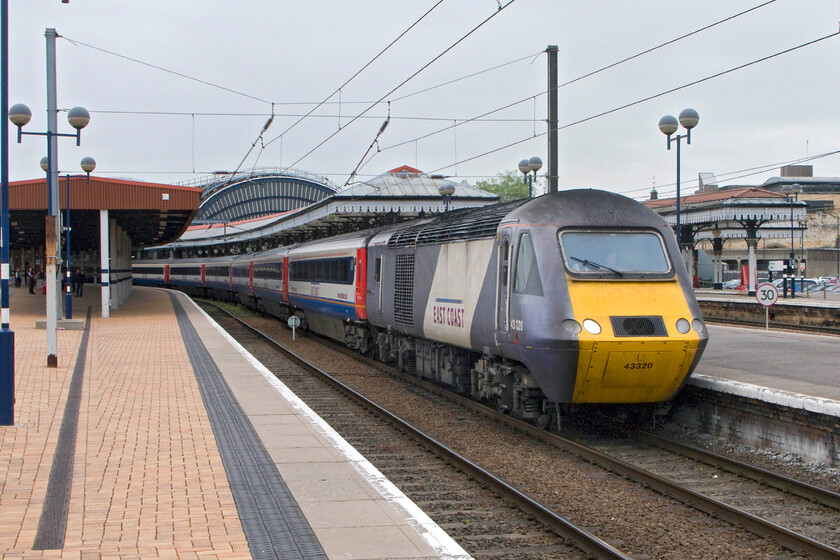 43320, GR 16.01 York-London King's Cross (1Y38), York station 
 The 16.01 York to King's Cross service stands at York with HST power car 43320 leading. The train is made up of a set of East Midlands Trains stock hired in due to shortages with East Coast power cars front and rear. 
 Keywords: 43320 16.01 York-London King's Cross 1Y38 York station East Coast HST East Midlands Trains