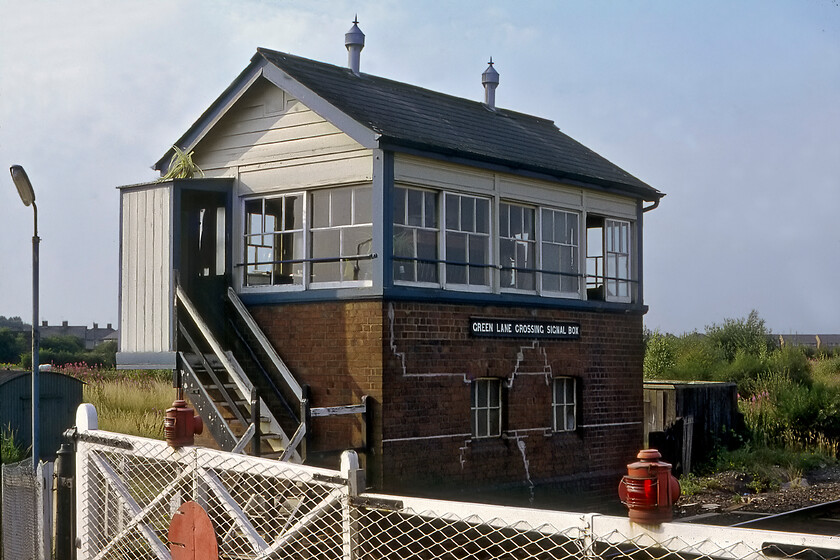 Green Lane Crossing signal box (GW, c. 1925) 
 Green Lane Crossing signal box contained a twenty-one lever frame and was the first box south of Saltney Junction (Chester) on the route towards Wrexham. It also controlled the delightful mechanical crossing gates with their red warning lamps seen in this photograph. Notice that the box appears to have some structural problems with some rather crude repairs to the masonry having been undertaken. The box is an example of the later and more economical design used by the GWR with a much simpler gabled roof. The box was shut in 1986 when the route was singled with control of the crossing coming under the auspices of Chester PSB via CCTV monitoring. 
 Keywords: Green Lane Crossing signal box (GW, c. 1925)