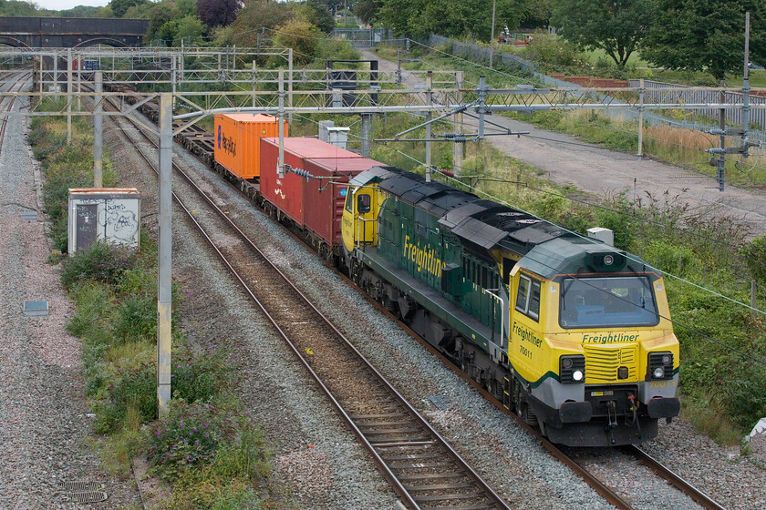 70011, 09.55 Crewe Basford Hall-Southampton MCT (4O35, 1L), site of Roade station 
 The 09.55 Crewe Basford Hall to Southampton Freightliner train passes through Roade at the site of the village's former station led by 70011. The passing of a Class 70 certainly makes a change from the monotony of Class 66s that haul what must be ninety per cent of the freight past this spot! 
 Keywords: 70011 09.55 Crewe Basford Hall-Southampton MCT 4O35 site of Roade station Freightliner