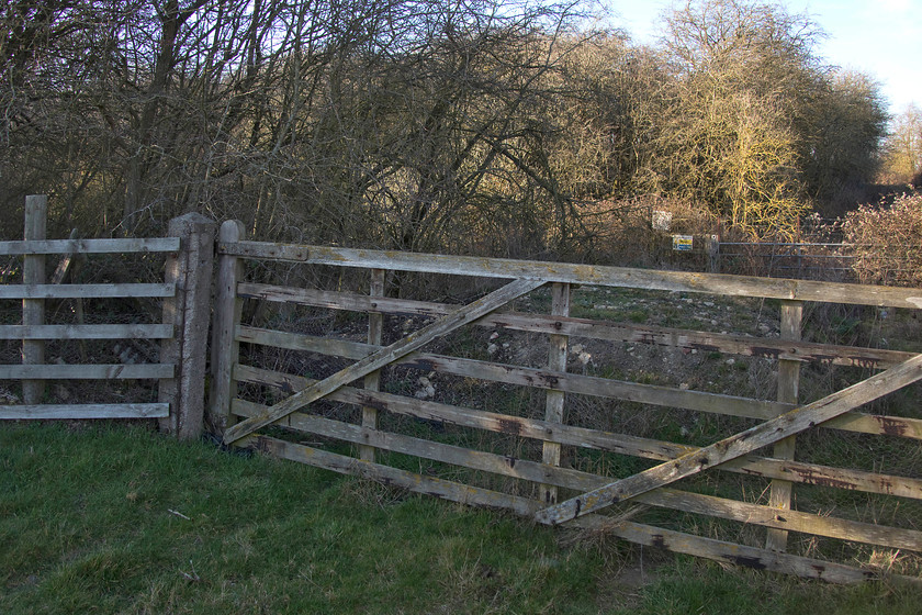 Former SM&J gate & crossing, Roade SP755509 
 Apart from the new pieces of wooden fencing to the far left and the galvanised gate in the background all this is original SM and J infrastructure. The concrete post and wooden gate protected the line from animals and the like with the track running left to right between the two gates. 
 Keywords: Former SM&J gate & crossing Roade SP755509