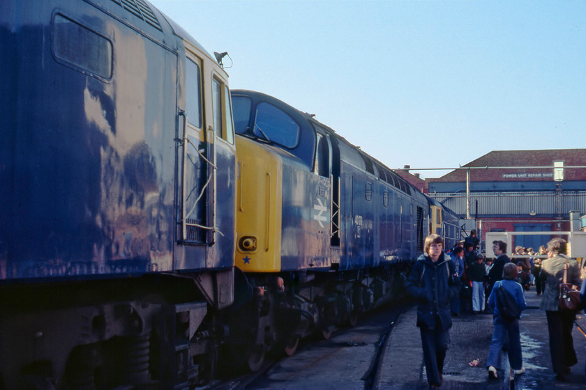 47042, 40179 & 47448, awaiting attention, Crewe Works 
 Wearing the prerequisite fur collar parka jacket, a spotter walks towards the camera at Crewe Works open day. To his right is 47042, which has its cab door roped off to prevent any impromptu cabbing! This class 47 was involved in a serious accident as 1623 near Sharnbrook on the MML when it collided with 5250 (25100) on 27.01.71. Both locomotives were involved in engineering trains during a possession of the MML, a report of the incident can be found at...... https://www.derbysulzers.com/25100.html In the middle of the image is 40179 that arrived at the beginning of July for main generator repairs leaving at the start of February 1980. Beyond the class 40 is 47448 that is present on the works for classified repairs. 
 Keywords: 47042 40179 47448 Crewe Works