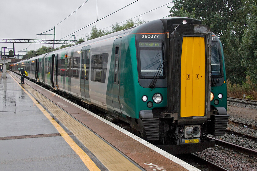 350377, LN 05.39 London Euston-Birmingham New Street, (2Y03, 7L), Northampton station 
 My train from Northampton to Birmingham New Street stands at Northampton station in the pouring rain! I travelled on board 350377 working the 05.39 Euston to New Street service and made use of the wifi on my laptop, finding that it actually was working - if a little slow! 
 Keywords: 350377 05.39 London Euston-Birmingham New Street 2Y03 Northampton station London Northwestern Desiro