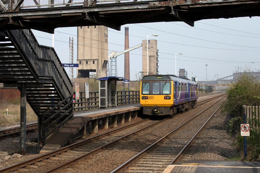 142015, NT 15.18 Darlington-Saltburn (2D46, 1L), South Bank station 
 142015 passes through South Bank station working the 15.18 Darlington to Saltburn. It is passing along the highly industrialised but now largely quiet area south of the River Tees towards Redcar. It is desolate scenes such as this with industry that has largely closed down makes one realise that the UK core industrial base has moved on to the next stage in its evolution. 
 Keywords: 142015 15.18 Darlington-Saltburn 2D46 South Bank station