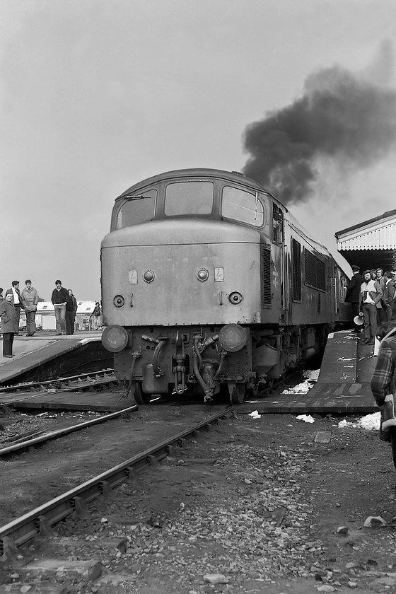 46013, outward leg of The Pines Express, 07.48 London Paddington-Weymouth (via Bristol & various freight lines), Westbury station 
 With a plume of exhaust 46013 comes off the stock of The Pines Express railtour at Westbury station. The Peak had brought the train from Bristol and was going to give way to a Class 37. Look at the people (including me) just wandering around off the end of the platforms with no more than a steward with a loud hailer to maintain order. 
 Keywords: 46013 The Pines Express 07.48 London Paddington-Weymouth Westbury station