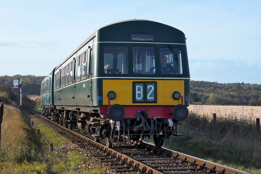 M56352 & M51188, 10.35 Holt-Sheringham, Weybourne TG123424 
 The class 101 DMU composed of M56352 and M51188 has just left Weybourne station with the 10.35 Holt to Sheringham working. It is now dropping down the gently sloping section of track to a point where it crosses the A149 coast road. There is no act of trespass involved in taking this picture, I am standing behind a fence at a newly constructed farm occupation crossing. In the 13 years that I have been visiting the NNR I have always found that they have a very enlightened and welcoming approach to enthusiasts. As long as you are wearing hi-viz and not in a silly spot, the drivers always give you a toot and a friendly wave. 
 Keywords: M56352 M51188 10.35 Holt-SheringhamWeybourne TG123424