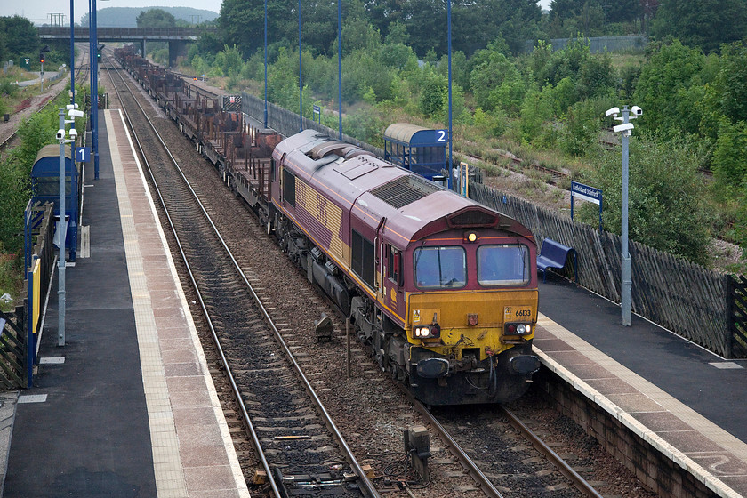 66133, 12.32 Lackenby B.S.C.-Scunthorpe B.S.C. (6D11), Hatfield & Stainforth station 
 DB are doing a very poor job of re-branding the class 66s that they acquired from EWS in a deal completed in November 2007! Not only is 66133 still in its EWS livery, but it also has full branding. Normal practice has been for the large EWS logo on the bodyside to be removed and a small DB red logo stuck over the cabside EWS three beasties. 66133 is leading the 6D11 12.32 Lackenby to Scunthorpe flat steel wagons through Hatfield and Stainforth station. 
 Keywords: 66133 12.32 Lackenby B.S.C.-Scunthorpe B.S.C. 6D11 Hatfield & Stainforth station