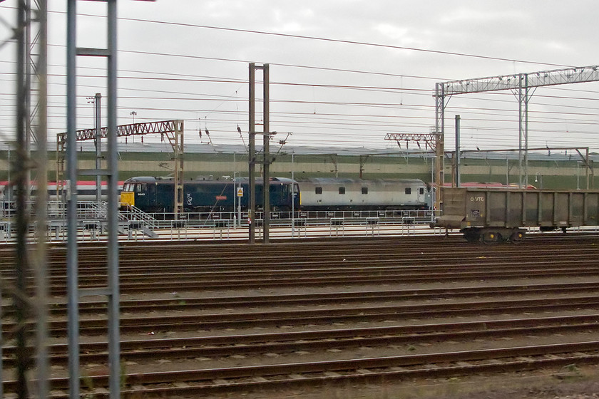 86401 & 96371 (Nightstar generator coach), Wembley TMD 
 Somewhat in the distance but an interesting subject in Wembley yard nonetheless. Firstly in its Caledonian Sleeper livery 86401 'Mons Meg' is seen stabled in between the movement of sleeper stock to and from here and Euston. Behind it is a former Nightstar generator coach number 96371. This generator coach was converted from former MK3 Sleeper 10545 in the early 1990s. These were to provide an electric supply for the rakes of Nightstar sleepers that were to operate from the UK through the Channel Tunnel and to various destinations across northern Europe. The generators were needed when the trains were being hauled by diesel power, planned to be Class 37s. The highly expensive Nightstar programme never came to fruition with the sleeper stock sold and exported to Canada with the various generators coaches finding a variety of uses throughout the UK. 
 Keywords: 86401 96371 Nightstar generator coach Wembley TMD Mons Meg AC Locomotive Group Caledonian Sleeper