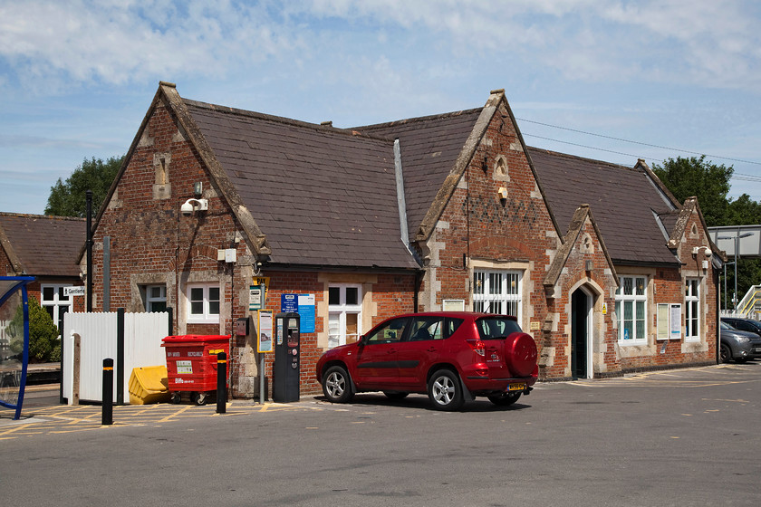 Frontage, Pewsey station 
 The Berks and Hants Railway opened its station at Pewsey in 1862. It initially had a single broad-guage line but over time it became standard gauge and was doubled by the GWR. Notice the waiting shelter constructed on the up platform. This was built in a similar style to the main building when the original structure was deemed unsafe and pulled down. 
 Keywords: Pewsey station