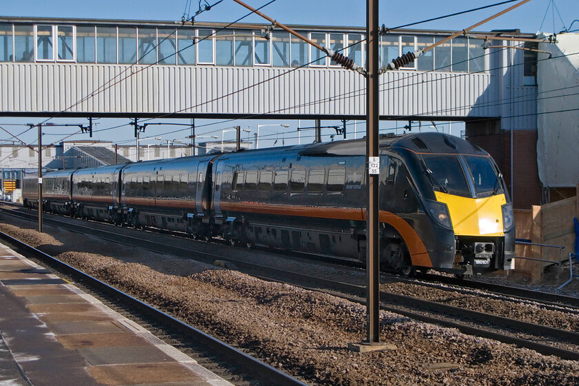 180101, GC 06.51 Bradford Exchange-London King's Cross, Peterborough station 
 180101 passes Peterborough at speed working Grand Central's 06.51 Bradford (Exchange) to London King's Cross. The black livery of the Class 180s, and their HST sets for that matter, is tricky to photograph well in bright light even more so when standing on the wrong side for the sun as is the case here! 
 Keywords: 180101 06.51 Bradford Exchange-London King's Cross Peterborough station Grand Central